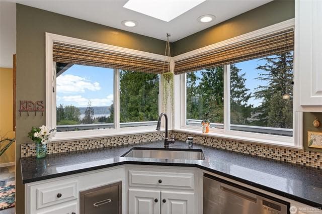 Kitchen with bay window framing the Olympic Mountain view, quartz counters