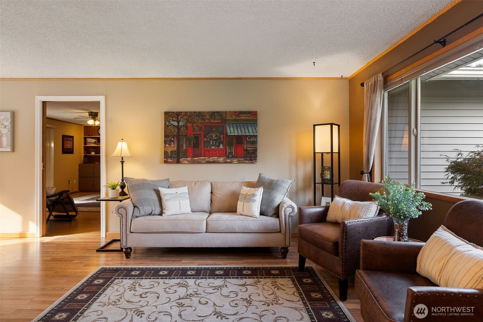 Living room with hardwood floors and a wall of windows at 17104 24th Ave SE, Bothell WA