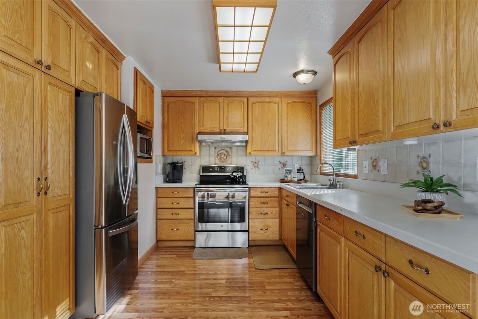 Oak kitchen with stainless appliances and generous counter space at 17104 24th Ave SE, Bothell WA