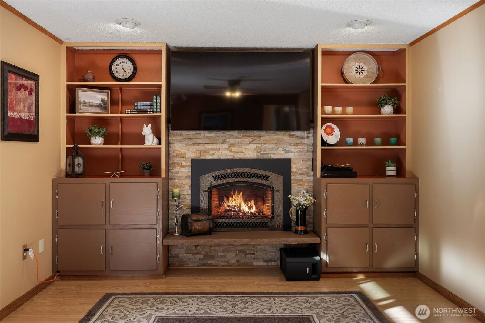Family room with a stone fireplace and built-ins at 17104 24th Ave SE, Bothell WA