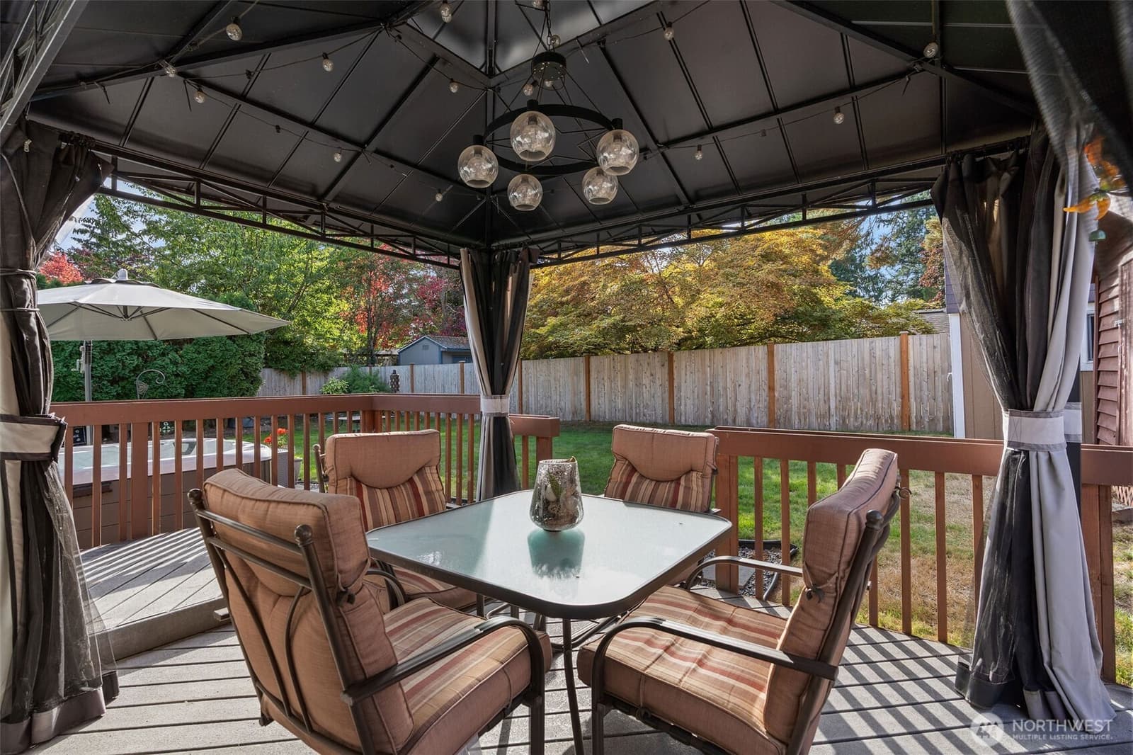 Covered gazebo and outdoor dining on the deck at 17104 24th Ave SE, Bothell WA