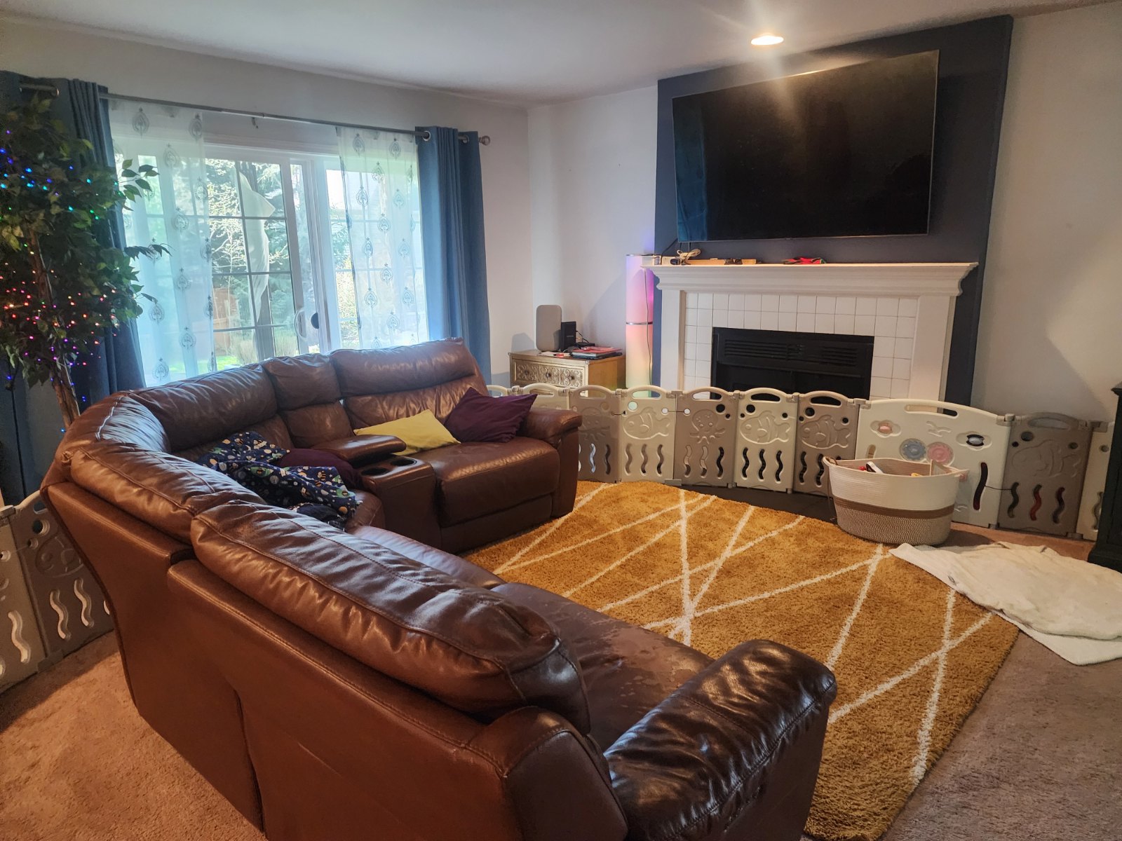 Living room before pre-sale prep — dated tile fireplace, dark accent wall, worn carpet